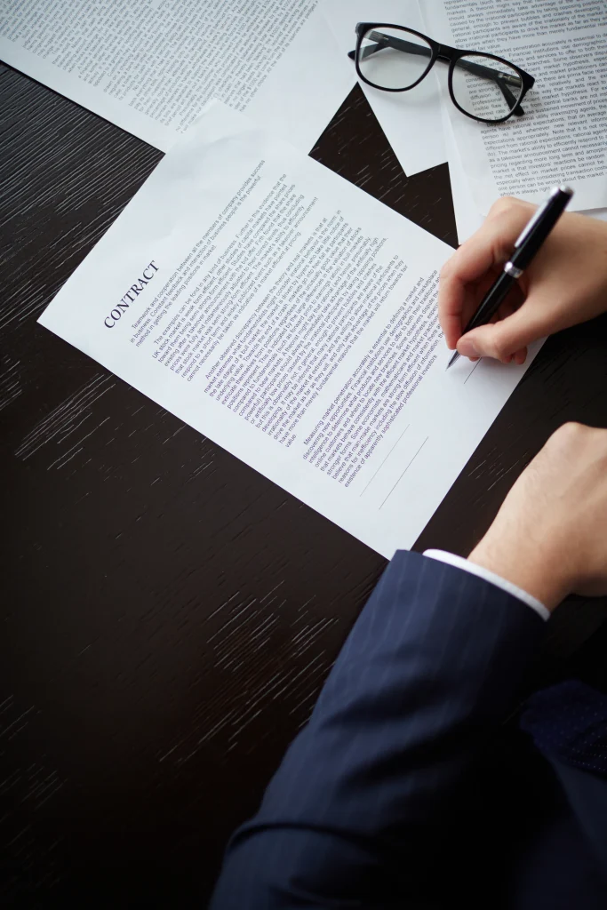 Businessman holding a pen and signing a contract